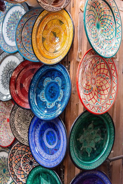 Colorful plates are displayed on a wall