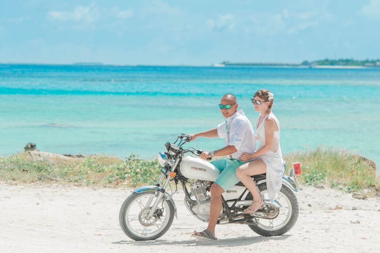 Man And Woman Riding Standard Motorcycle