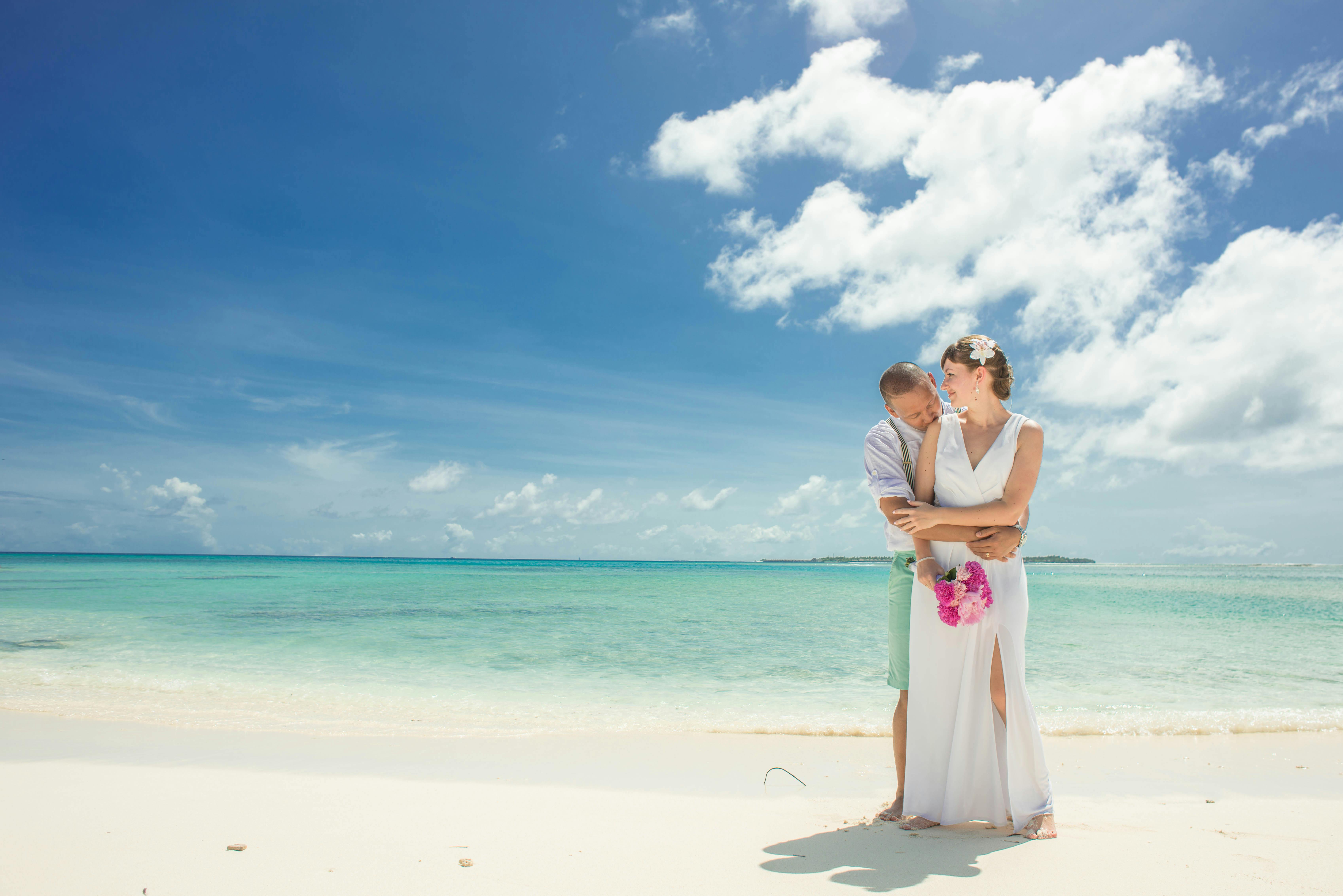 Man And Woman Standing Near Body Of Water · Free Stock Photo