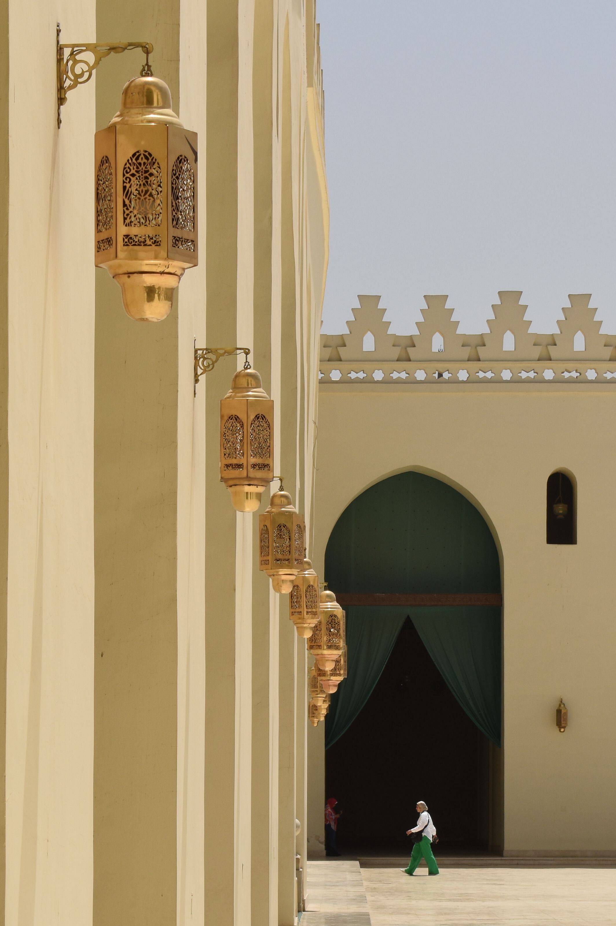 Traditional Islamic architecture at Al Hakim Mosque in Cairo, featuring ornate hanging lanterns.