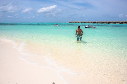 Man Standing on Beach Line