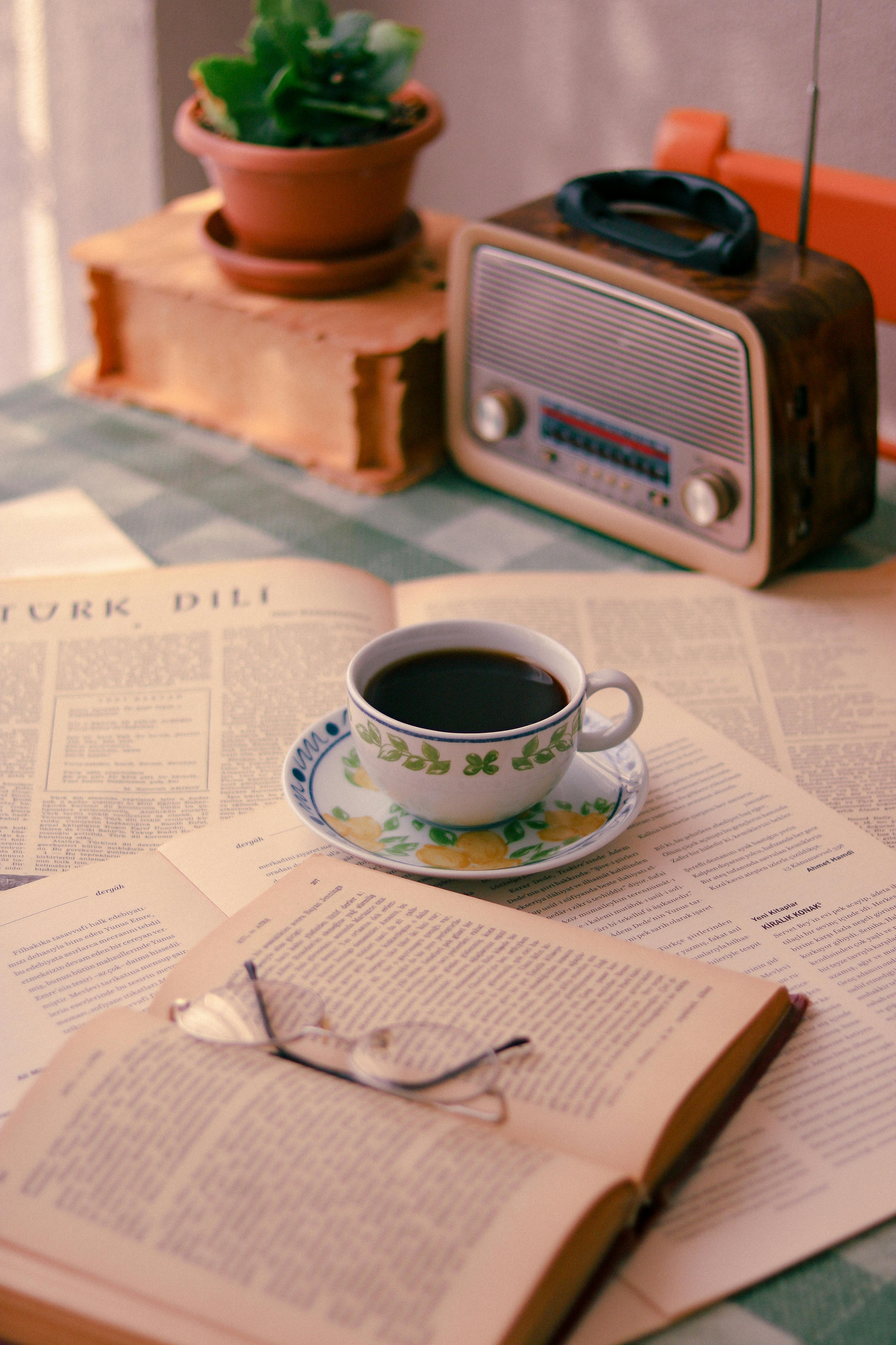 cup of coffee on open books