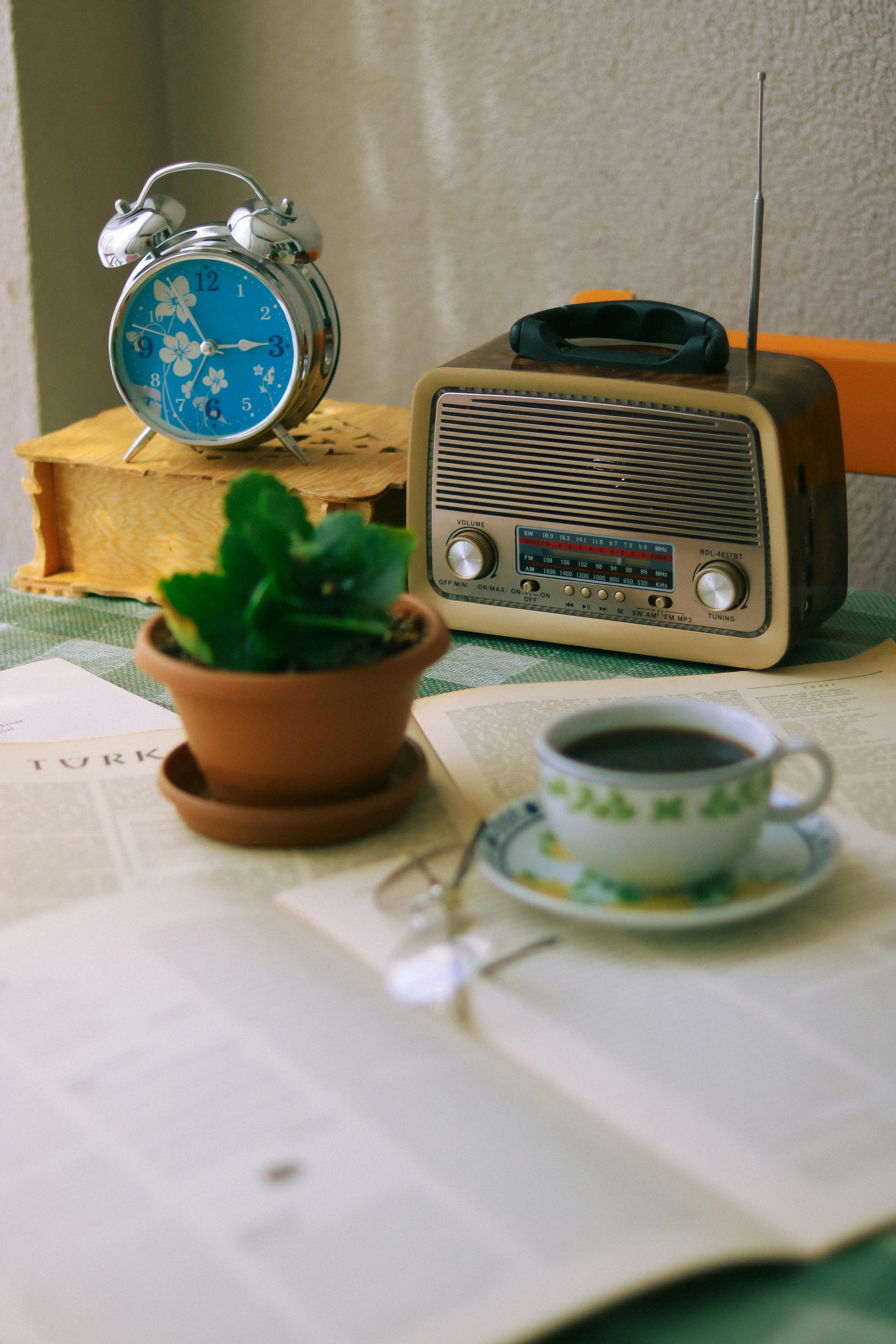 Cozy vintage breakfast setting with retro radio, clock, and coffee cup.