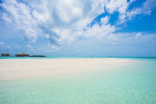 Free Pristine tropical beach with turquoise waters and blue skies, perfect for a serene getaway. Stock Photo
