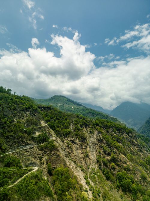 Free Breathtaking view of the Himalayas with lush greenery and cloudy skies, perfect for trekking and adventure. Stock Photo