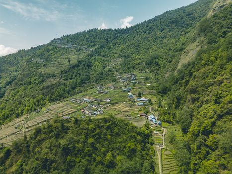 Stunning aerial view of terraced fields and mountainous landscape in Ghandruk, Nepal.