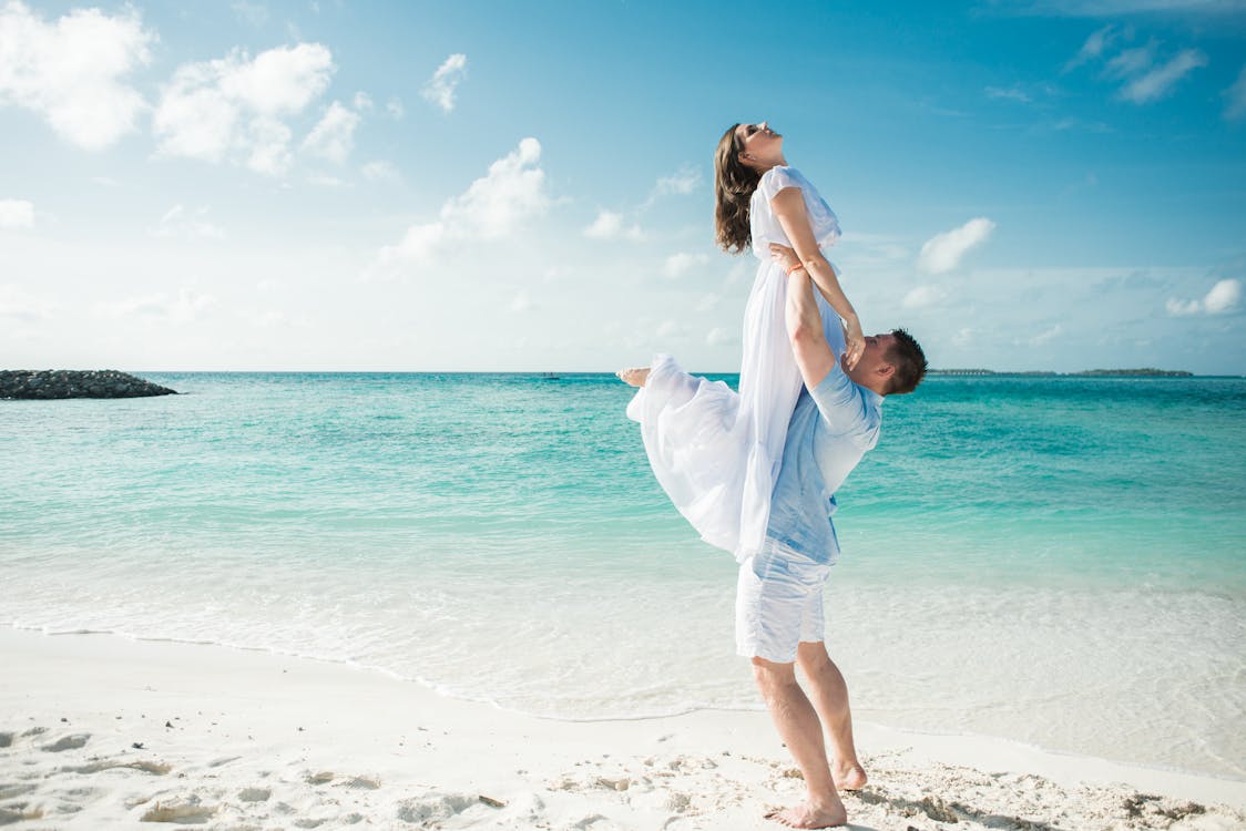 A happy couple at a seashore on a beach.