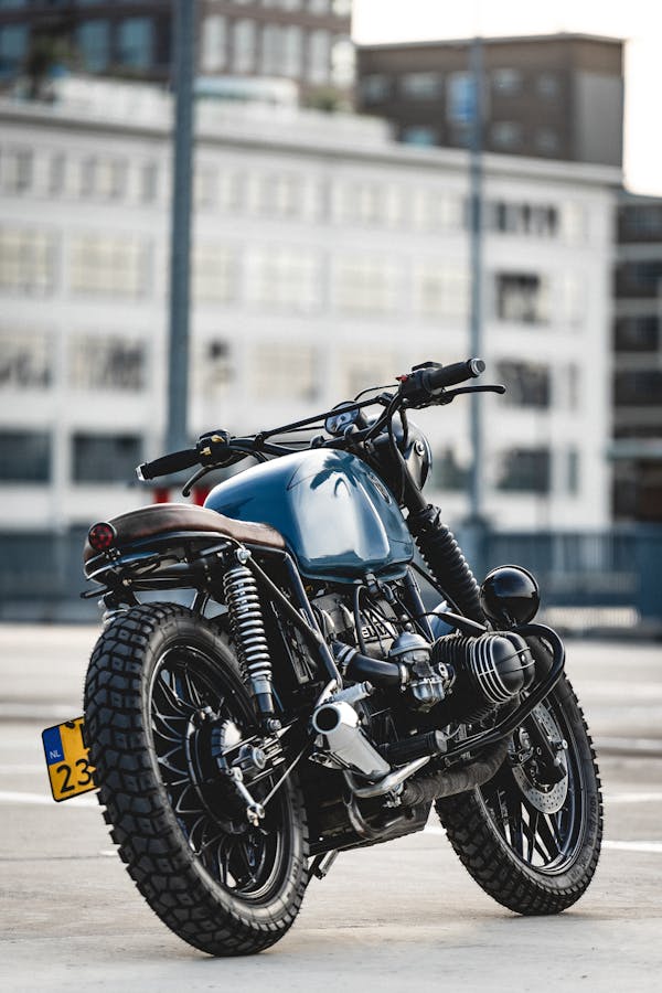 Selective Focus Photo of Parked Blue and Black Cafe Racer Motorcycle