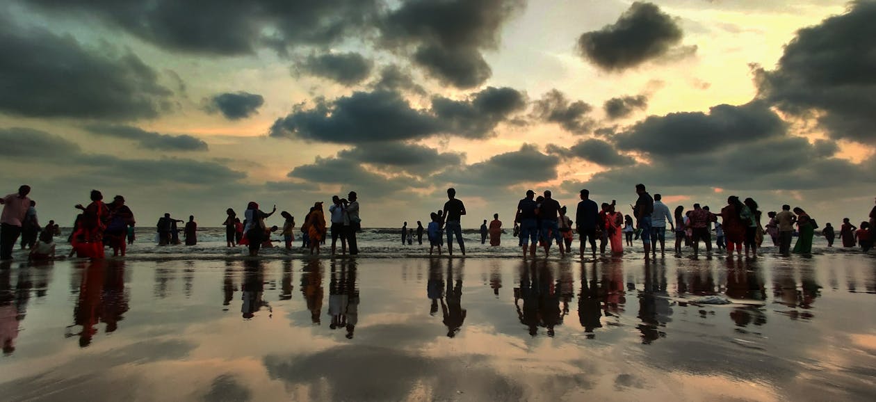 People on Wet Ground Under Gray Sky