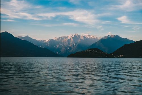 Free Tranquil view of a serene mountain lake and majestic peaks under a clear sky. Stock Photo