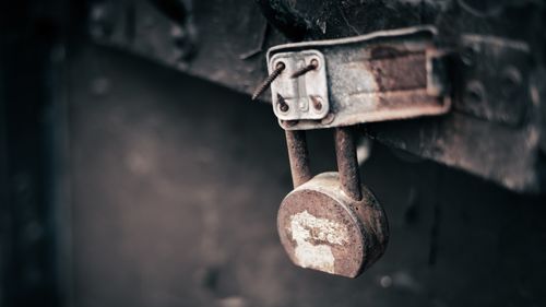Free Close-up of a rusty padlock on a decaying latch in San Juan, Puerto Rico. Stock Photo