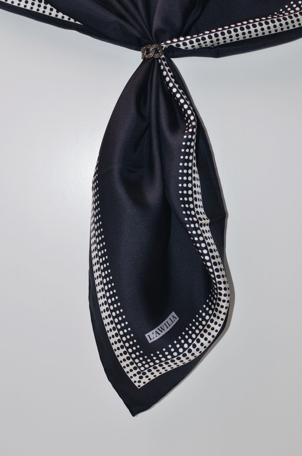 Close detail of a scarf edge, hem rolled by hand