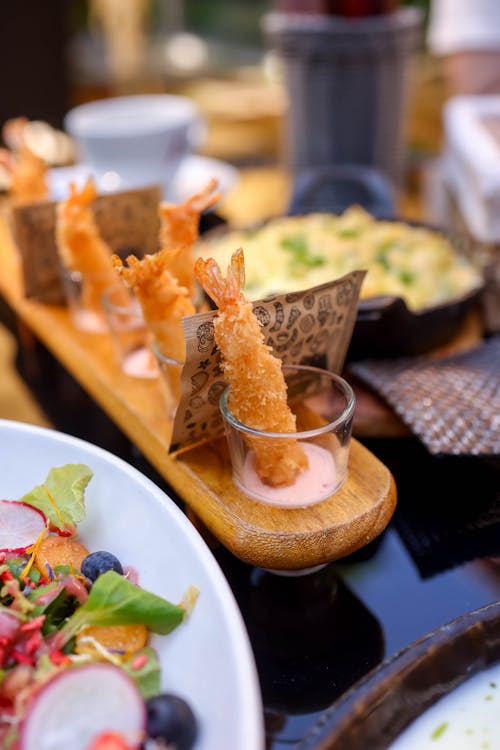 A tray of food with shrimp and salad on it