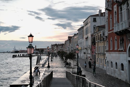 A walkway along the water with a lamp post