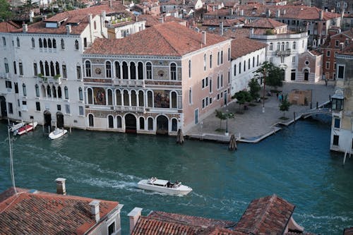 A boat is traveling down a canal in venice