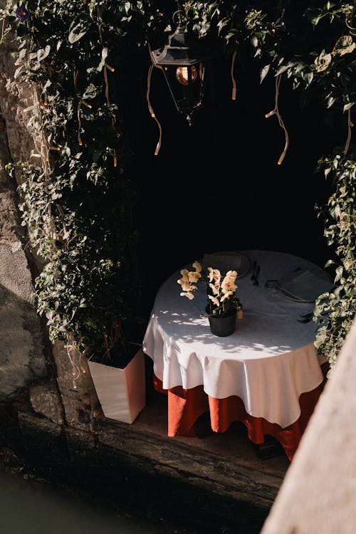 A table with a white cloth and flowers on it