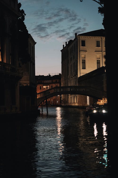 A boat on a canal at night in venice