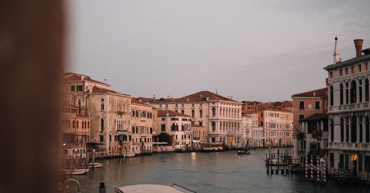 Explore the timeless beauty of Venice's historic canals and architecture at twilight.