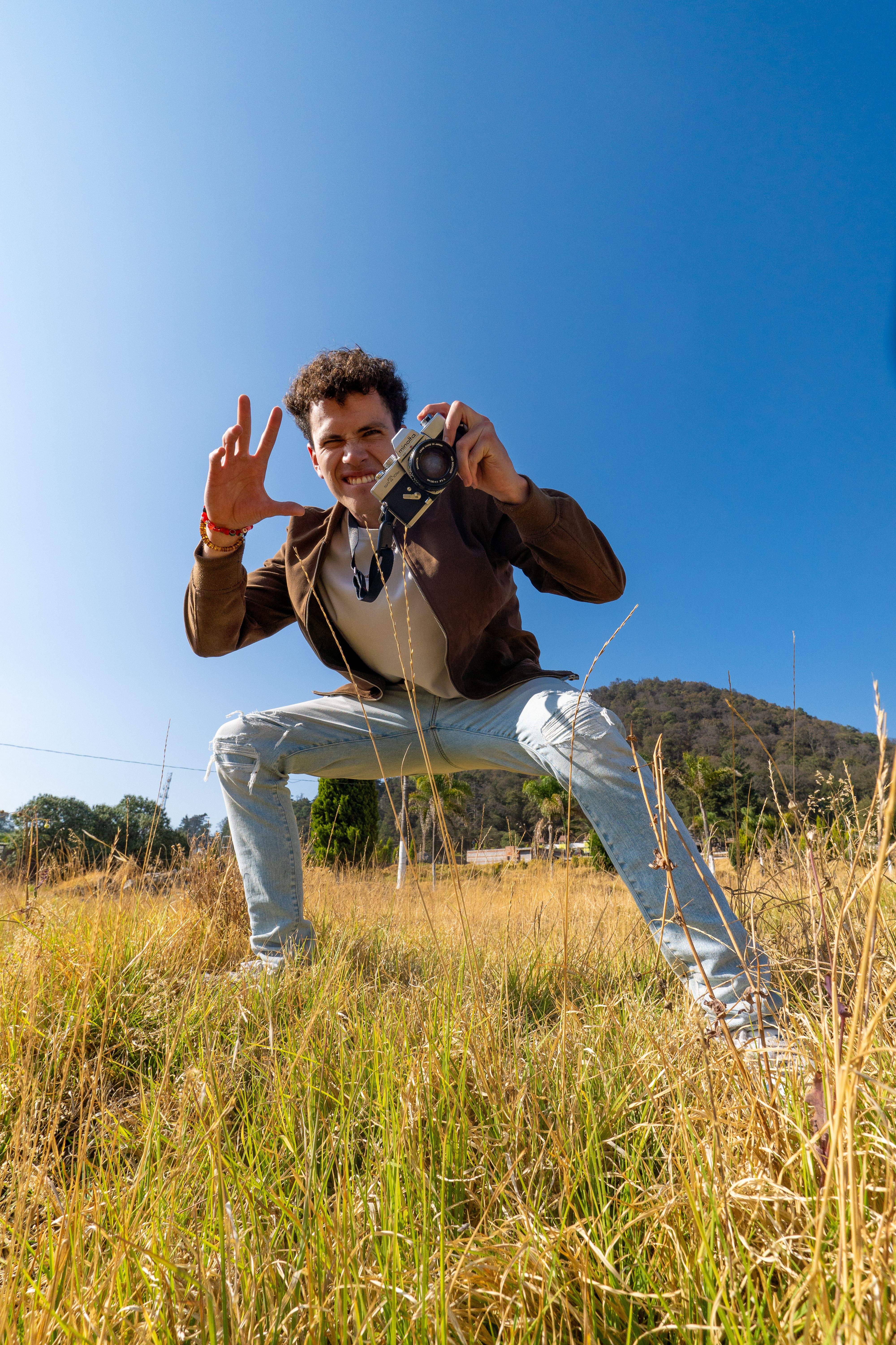 A man with a camera enjoying a sunny day in Amecameca, Mexico, capturing the beauty of nature.