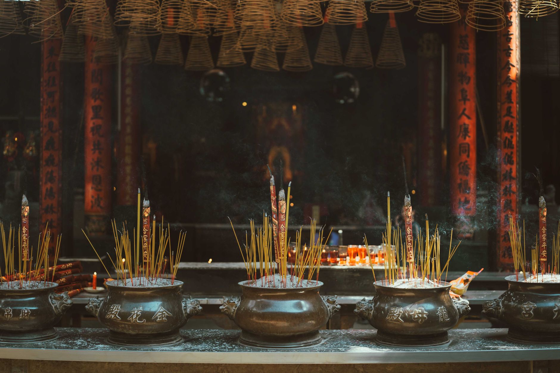 Traditional incense burning ritual at a temple in Ho Chi Minh City, Vietnam, evoking spirituality and culture.