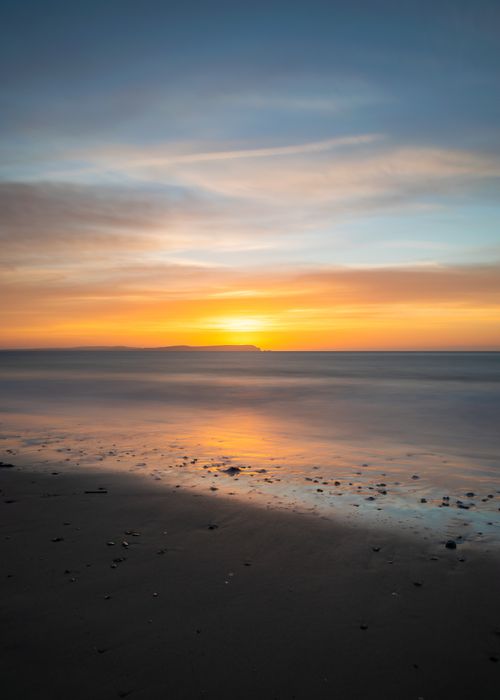 Free Captivating sunset over Bournemouth Beach with calm sea and colorful sky. Ideal for travel and nature themes. Stock Photo