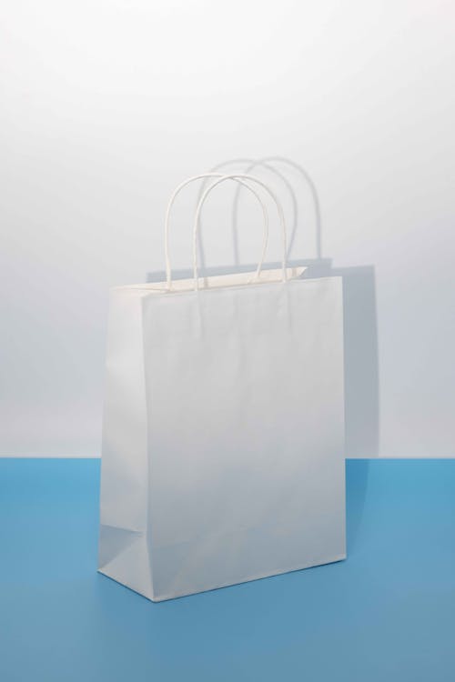 A white paper bag on a blue background