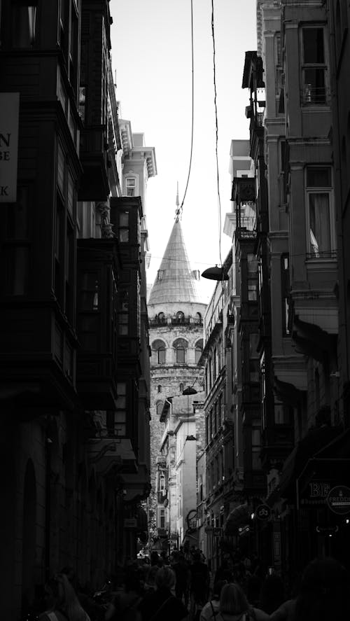 A black and white photo of a narrow street