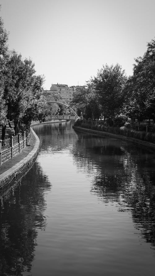 A black and white photo of a canal