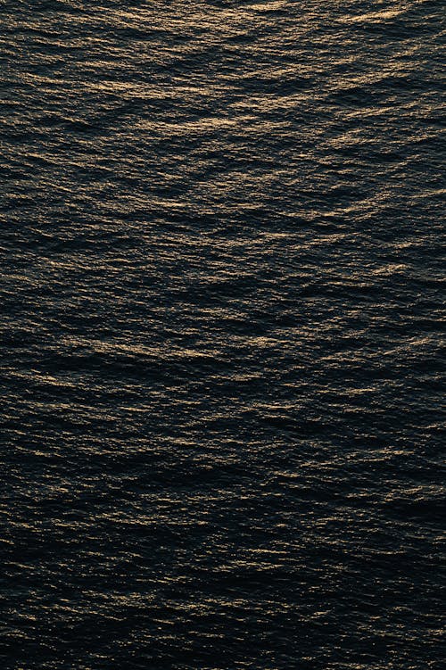 A sunset over the ocean with a black background