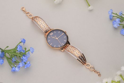 Stylish rose gold wristwatch with intricate designs and floral accents, perfect for elegant fashion.