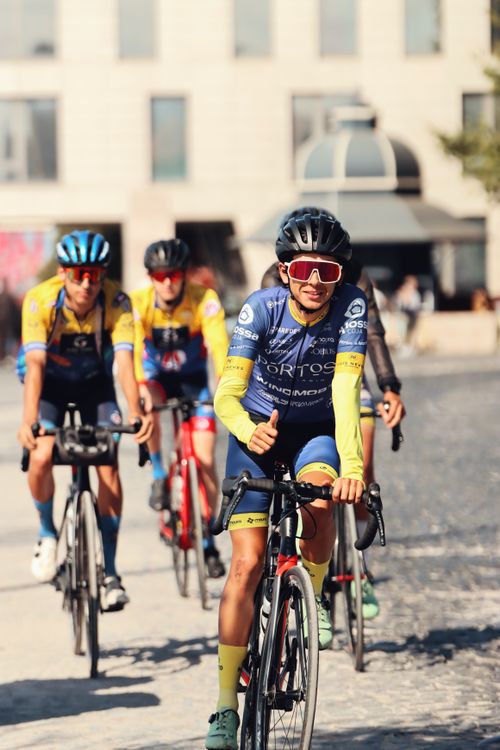 Free Group of cyclists racing on a sunny day in Lisbon, showcasing motion and fitness. Stock Photo