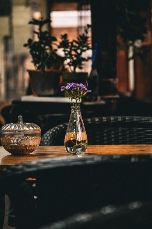 Free Stylish floral decoration in a glass vase on a restaurant table, creating a warm ambiance. Stock Photo