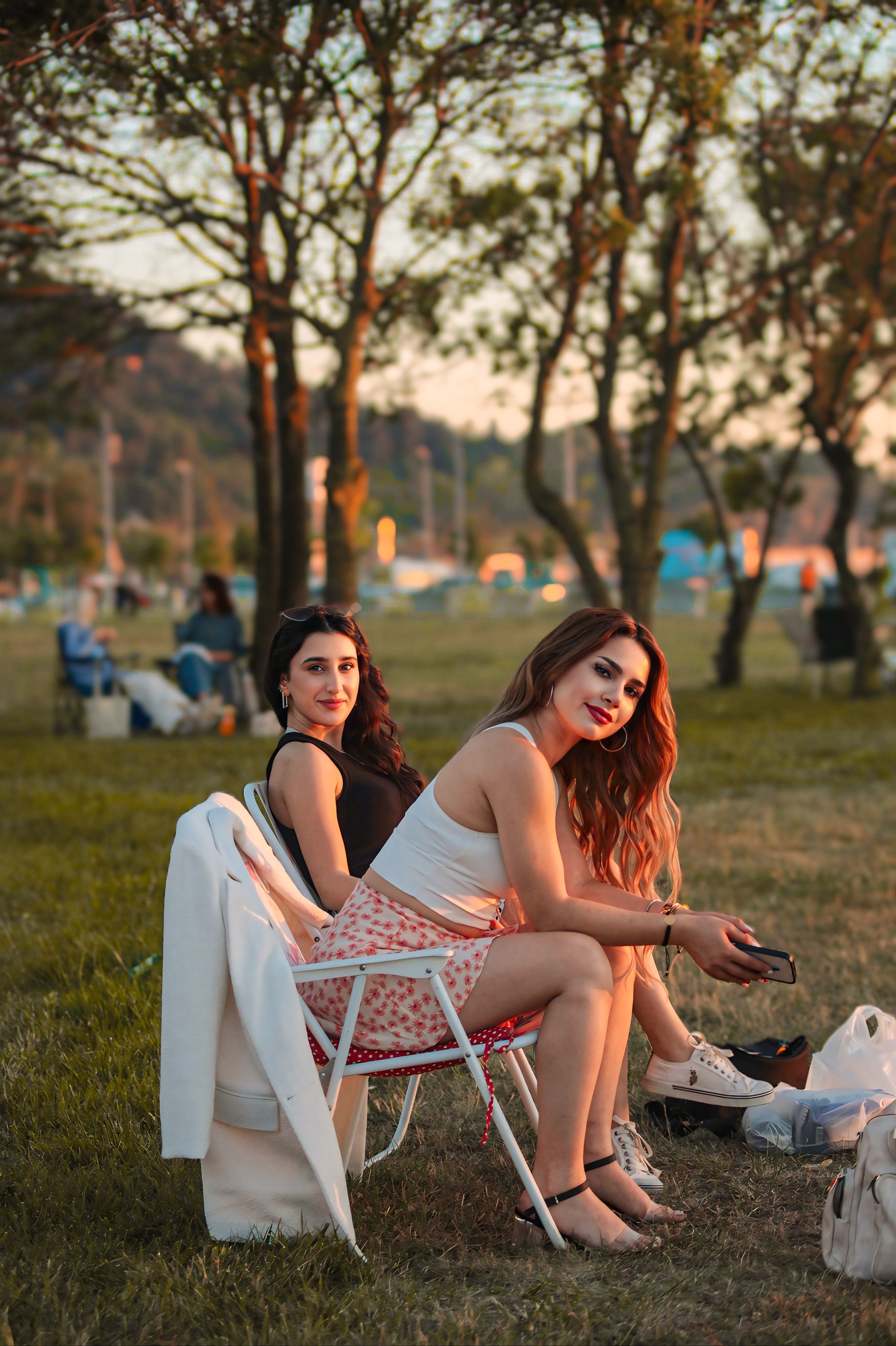 Women Sitting on Chairs at Park · Free Stock Photo
