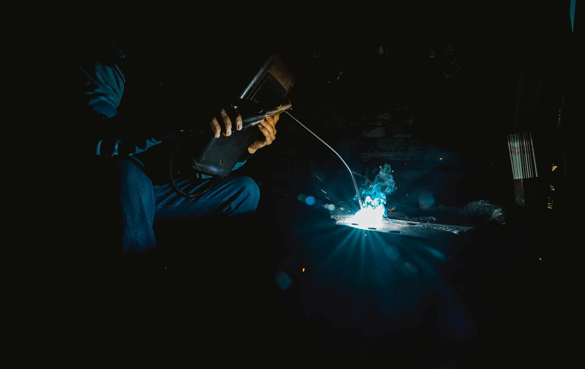 Welder Working in Dim Room