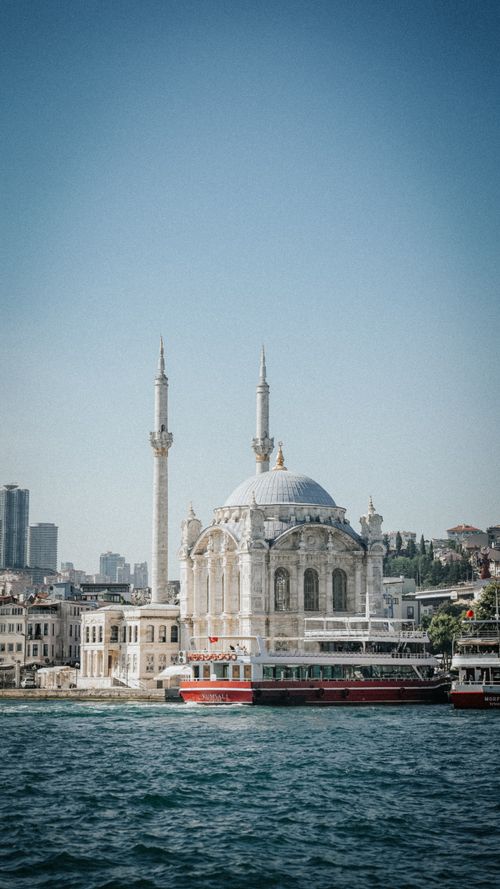 Free Ortaköy Mosque by the Bosphorus in İstanbul, with cityscape and boats. Stock Photo
