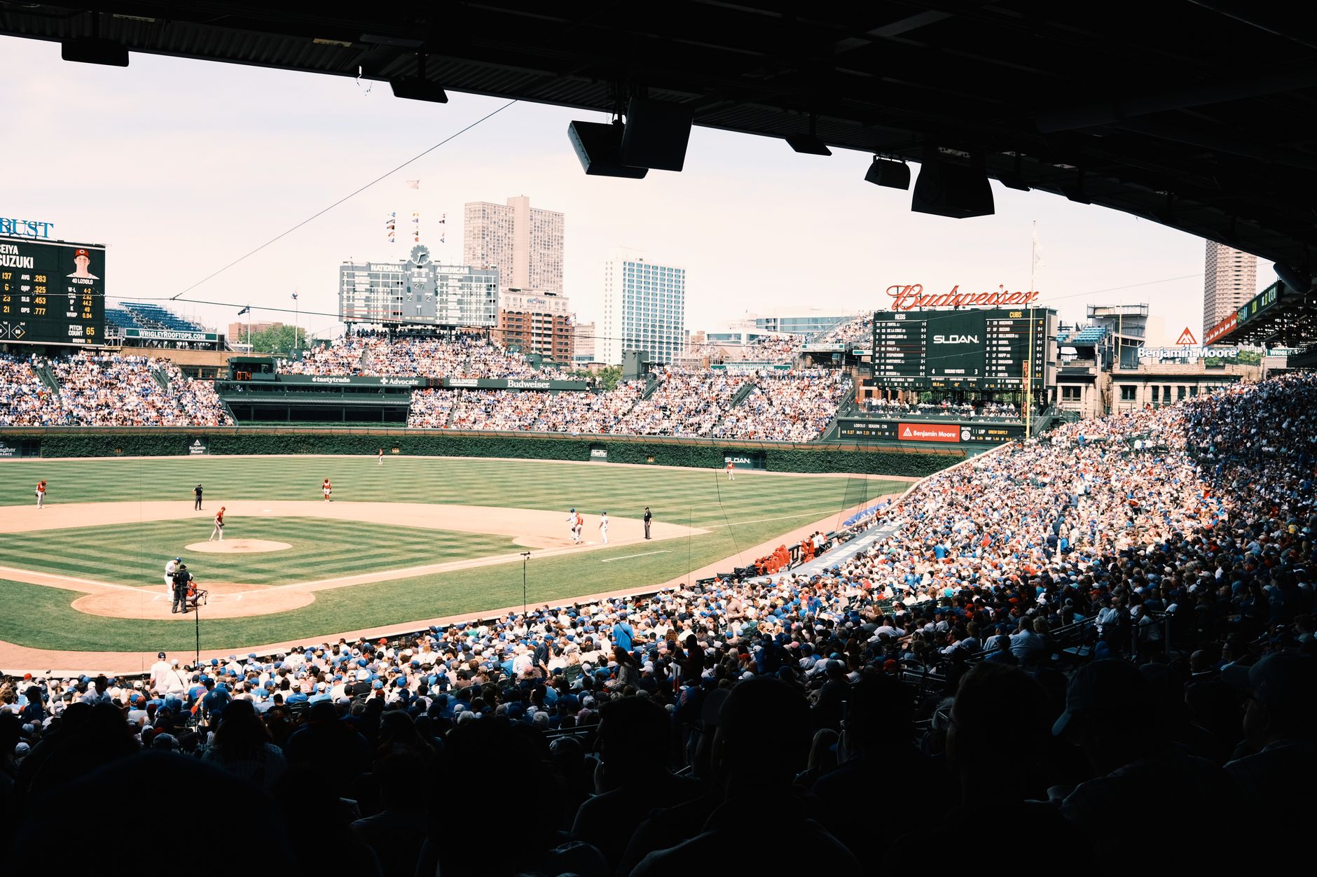 NCAA Baseball photo featuring A lively baseball game at Wrigley Field with a packed crowd in Chicago, Illinois.