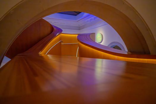 Curved modern architectural interior in Toronto's museum displaying elegant lighting.