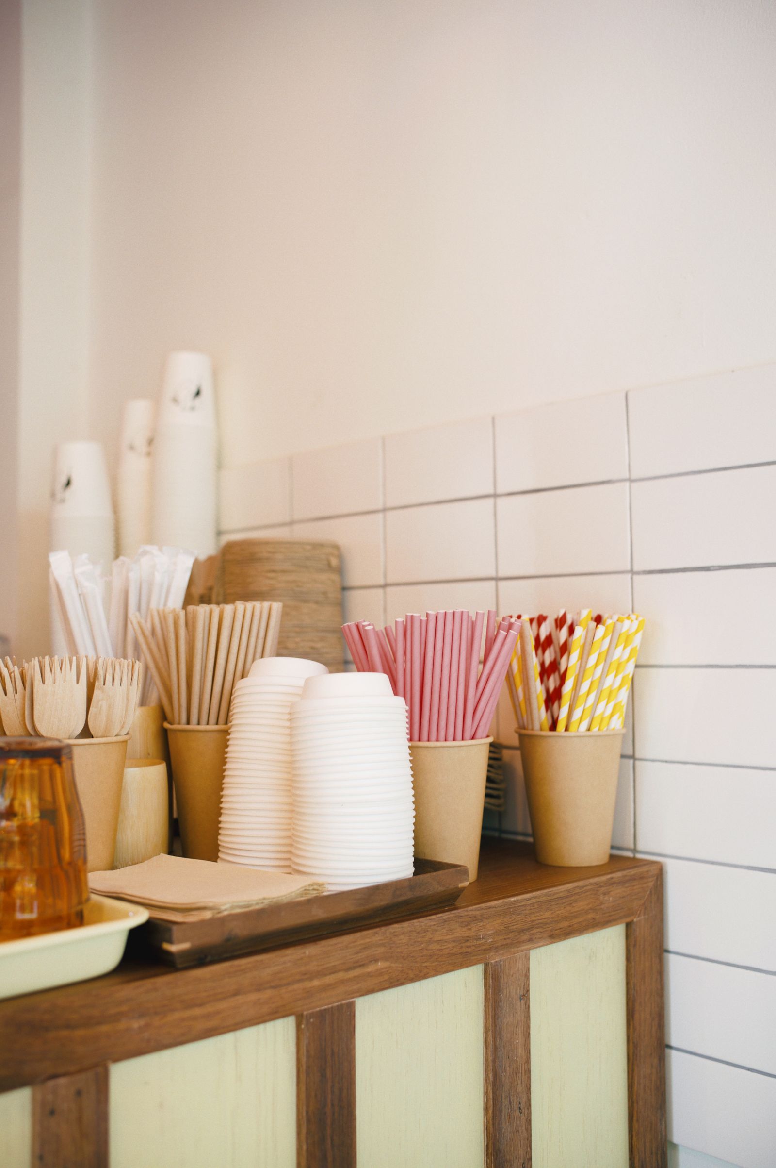 Cafe counter with paper cups, bowls, forks and straws