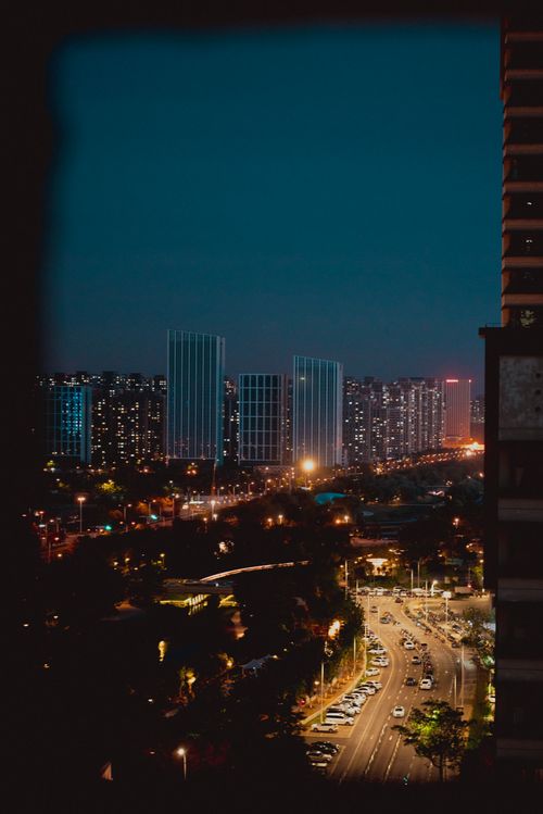 Free A bustling city skyline at night showcasing illuminated roads and high-rise buildings. Stock Photo