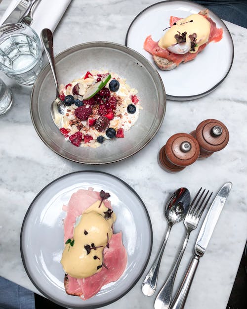 Eggs Benedict on White and Black Ceramic Plates