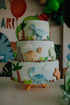 Three-tier dinosaur-themed cake for a children's birthday party.