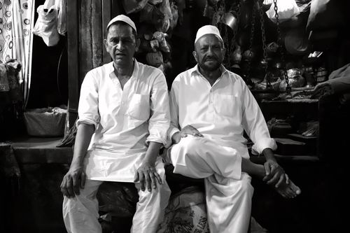 Free Black and white photo of two men in traditional attire sitting indoors, Delhi, India. Stock Photo