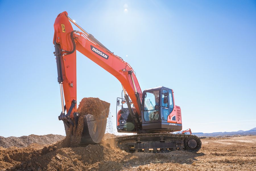 Construction equipment preparing a graded dirt surface