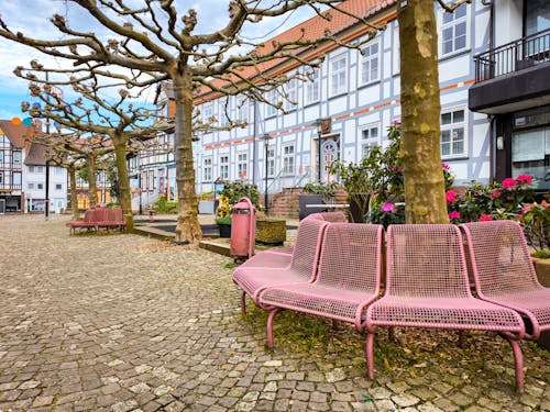 A pink bench sits in front of a building