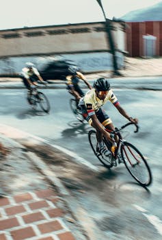 Intense bicycle race with athletes speeding through urban streets, showcasing agility and competition.