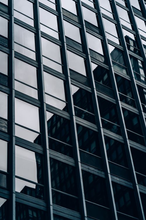 Free Close-up view of a modern skyscraper's glass and steel facade in downtown Chicago. Stock Photo