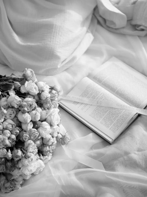 Free A book and flowers on a bed Stock Photo
