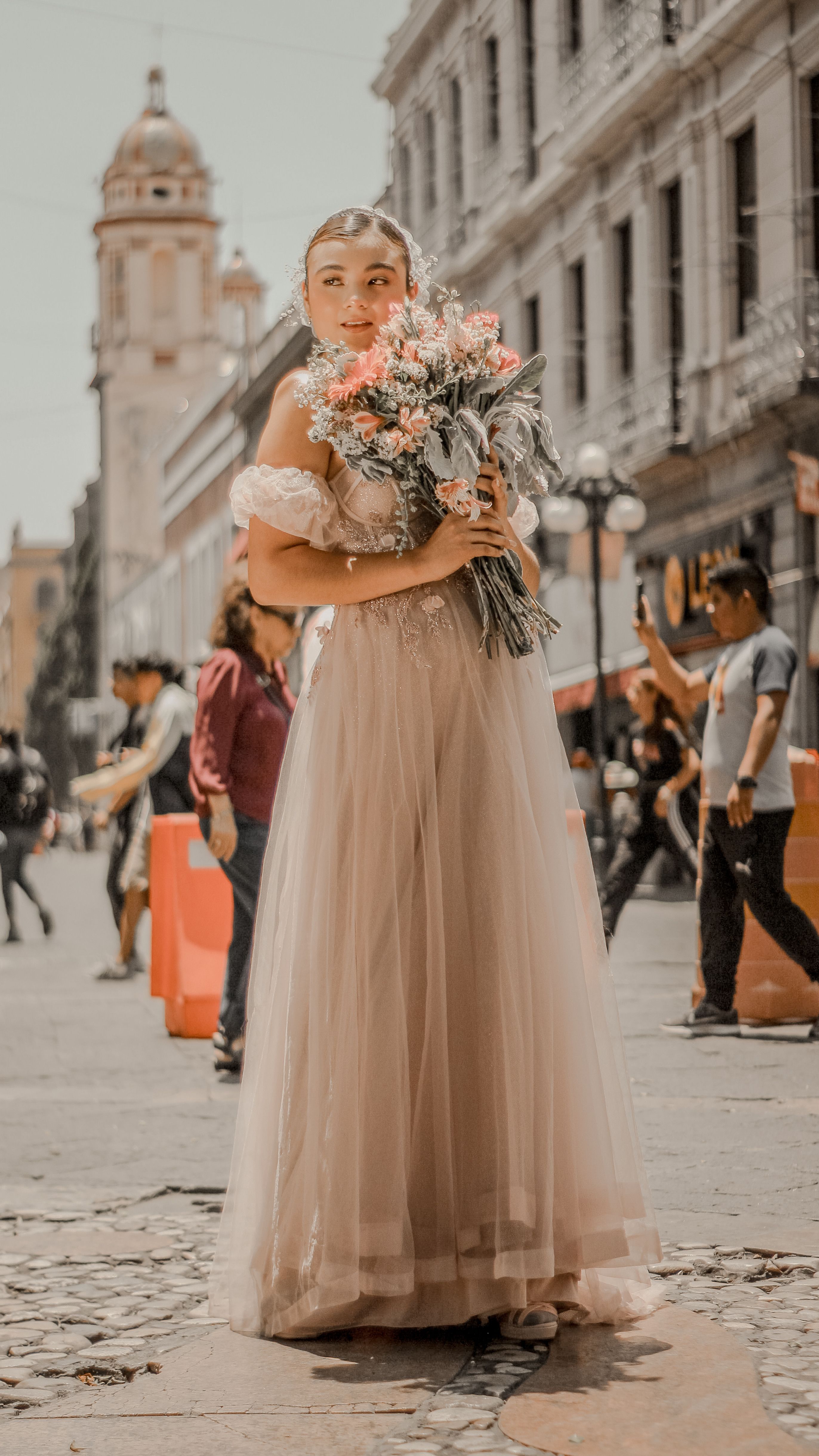 Woman in Dress Standing with Flowers Bouquet on Street · Free Stock Photo