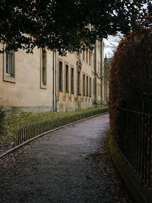 A path leading to a building with a fence