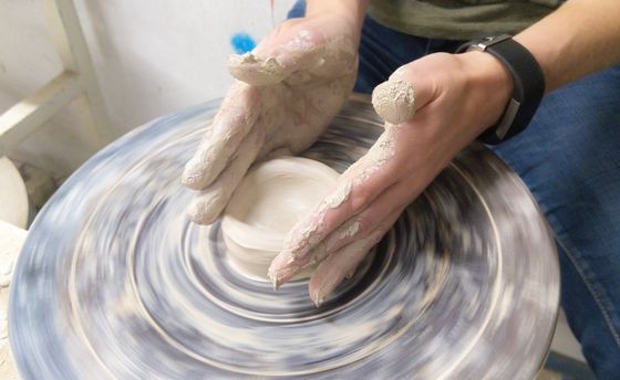 Hands centring clay on a pottery wheel, photo by ClickerHappy on Pexels